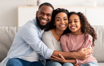 happy Afro-American family of three with perfect smiles